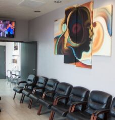 A waiting room with a tv at Sinus Relief Center