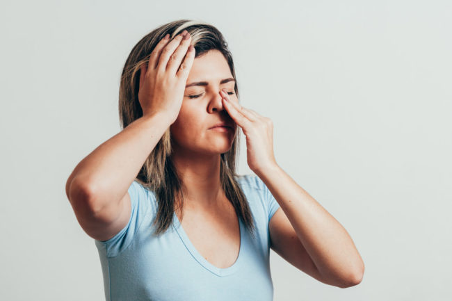 A woman with sinus and eye pain